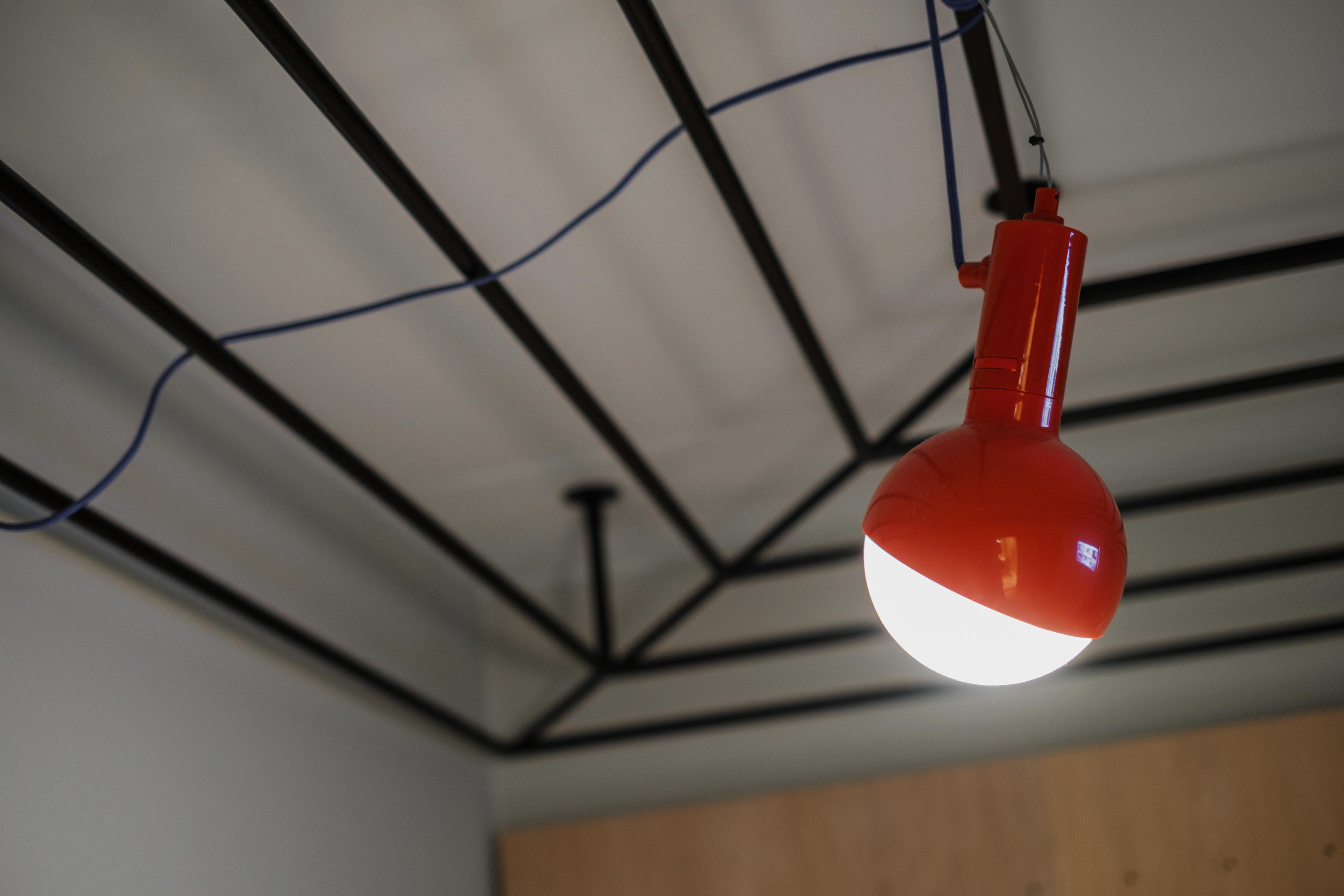 A red Hobo Lamp from the Studio Aisslinger-designed collection is hanging from the roof in a Sleeper room at Hobo Hotel in central Stockholm.
