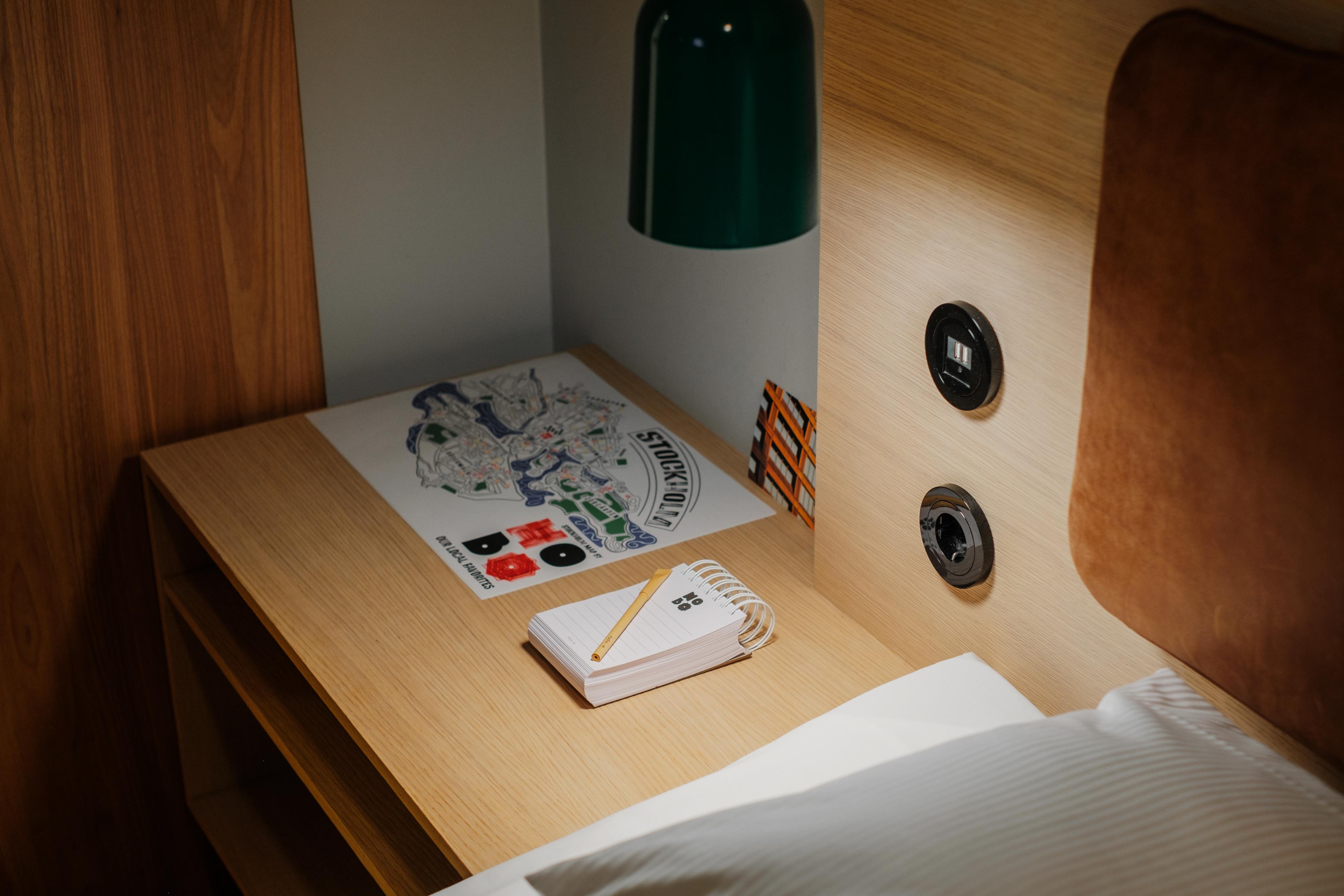 Map of Hobo Hotel’s favorite spots in Stockholm and notebook for personal notes, in a Sleeper room.