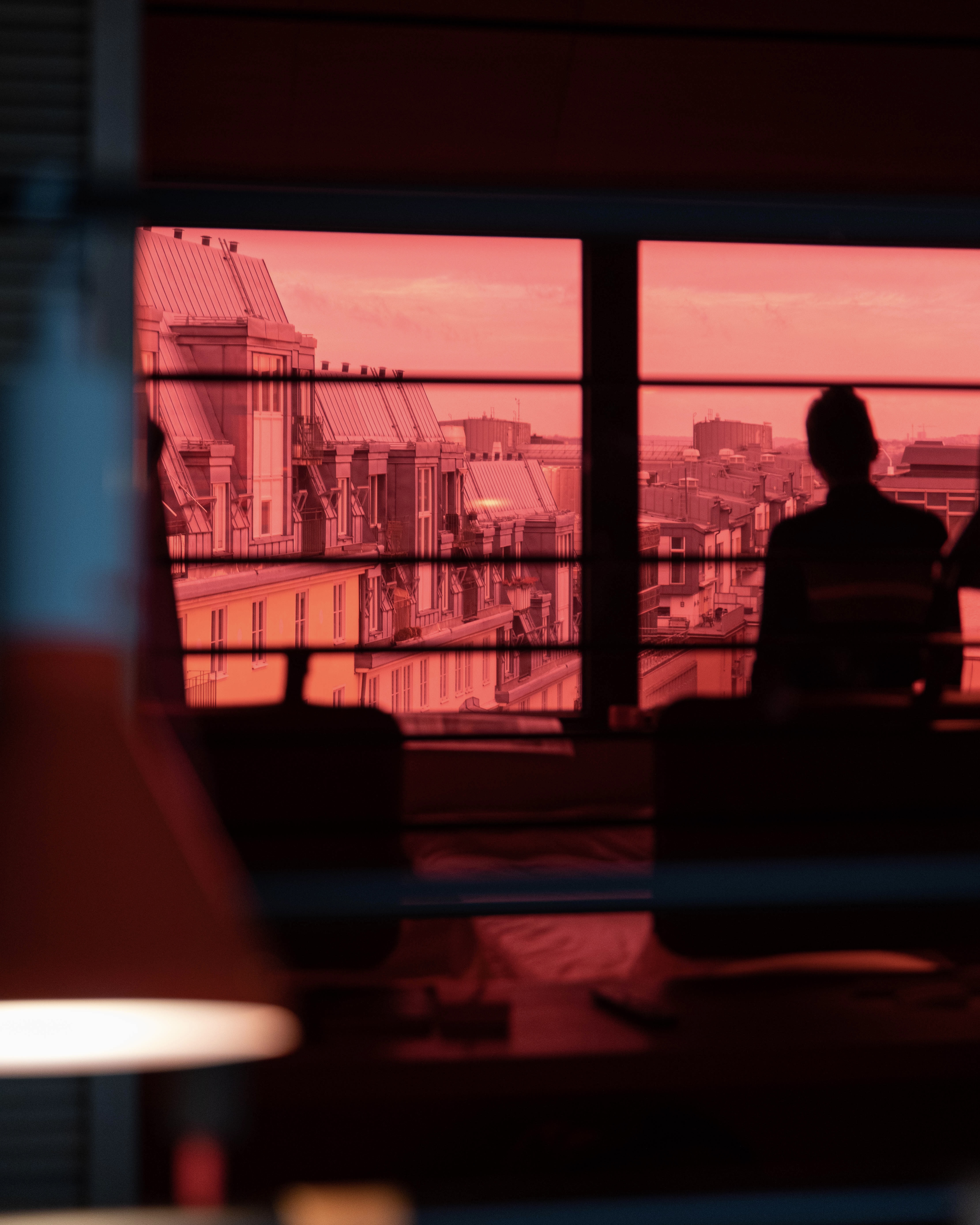 Superior room at Hobo Hotel in central Stockholm with a rooftop view, reflected in a red mirror.
