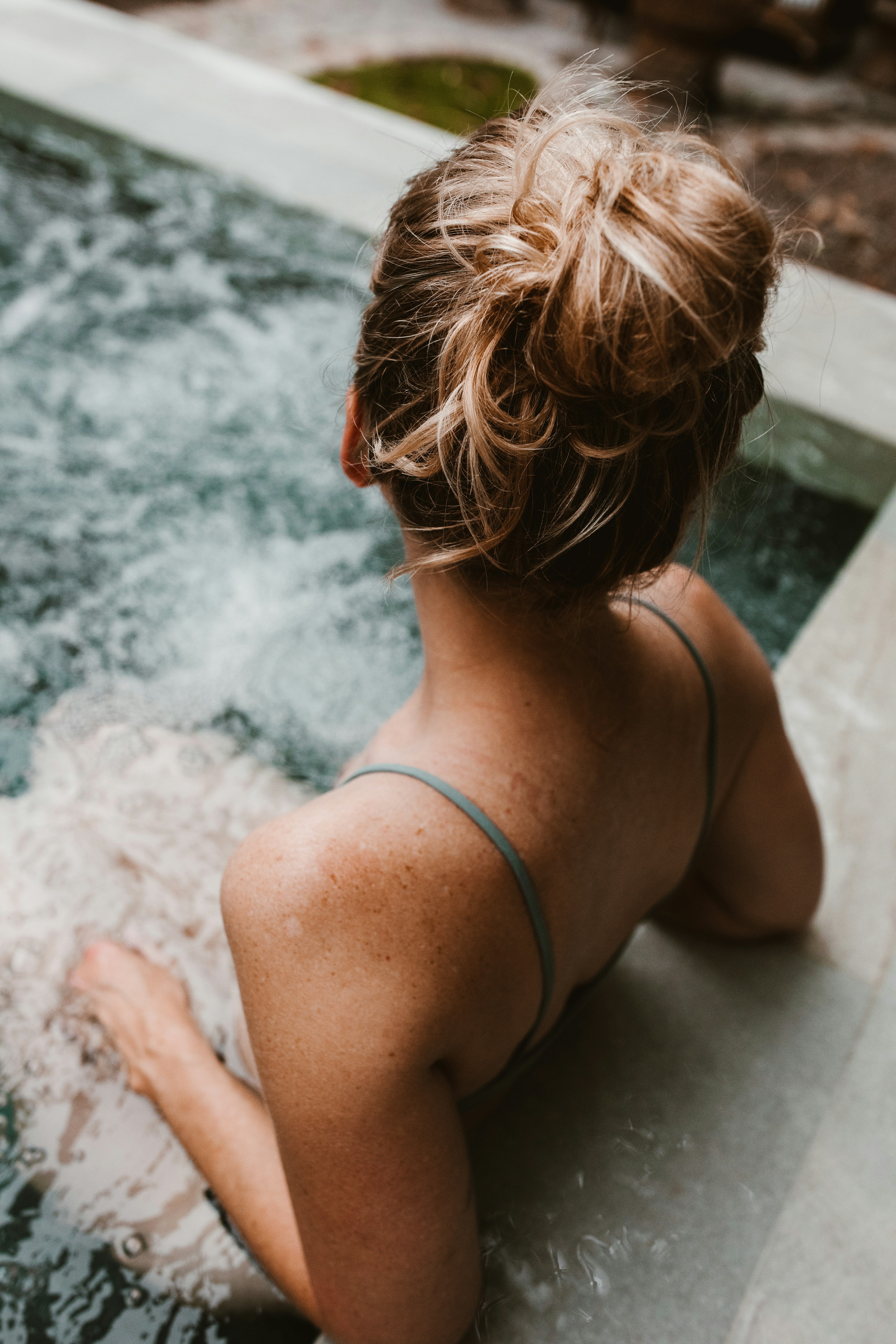 A woman sitting in a hot tub